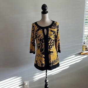 INC size medium yellow and black tunic with keyhole opening in front.